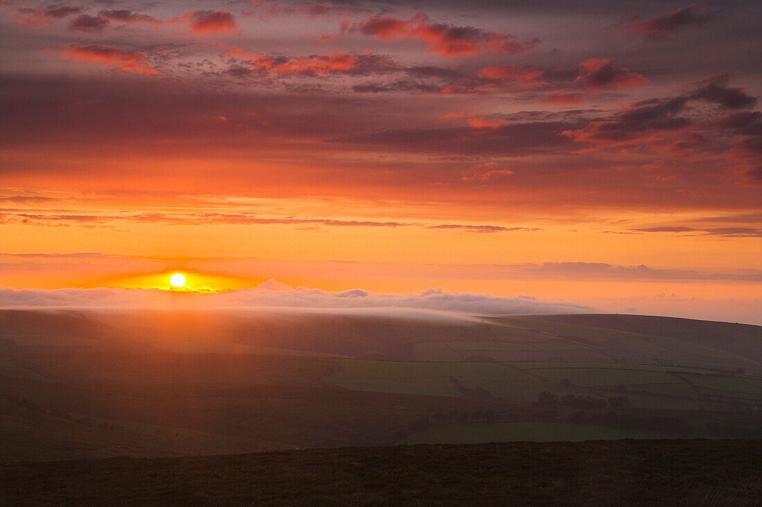 Sunset and Mist rolling in over the Hills Exmoor National Park Somerset