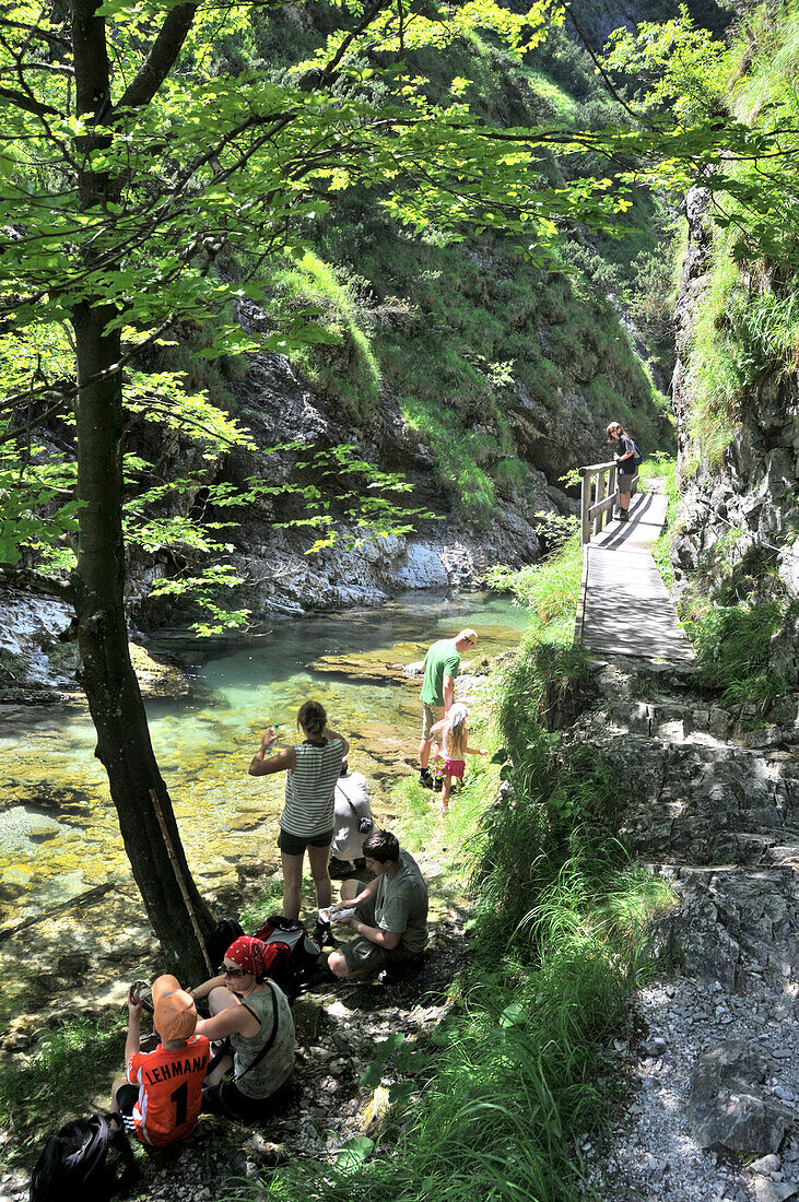 Hikers having a rest, Weissbach gorge near Bad Reichenhall, Berchtesgadener Land, Upper Bavaria, Bavaria, Germany