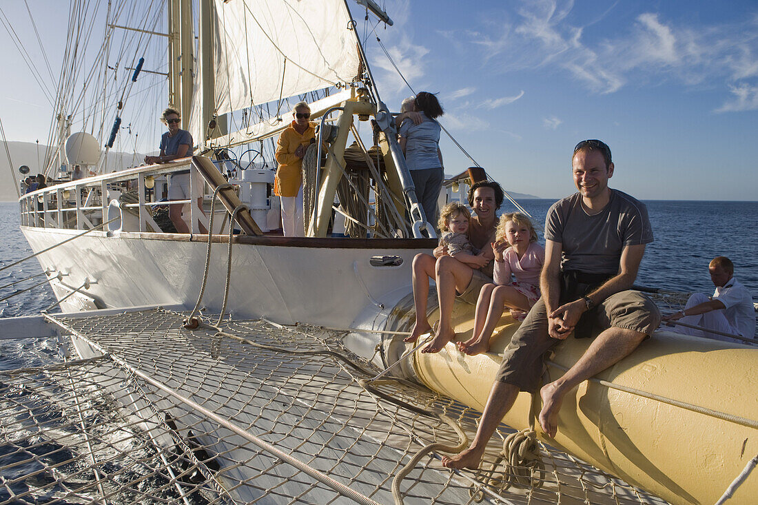 Young Family on bowsprit of sailing cruiseship Star Flyer (Star Clippers Cruises), near Bastia, Corsica, France