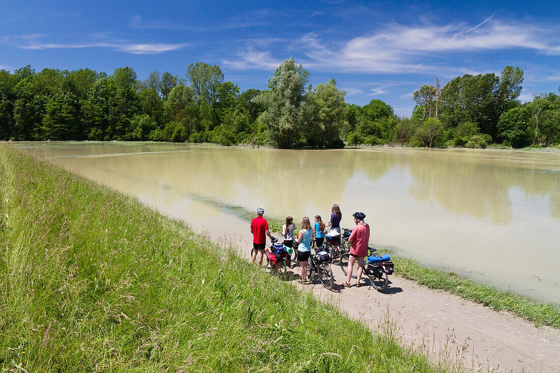 Cyclists on flooded Isar Cycle Route, Isarmuend, Lower Bavaria, Germany