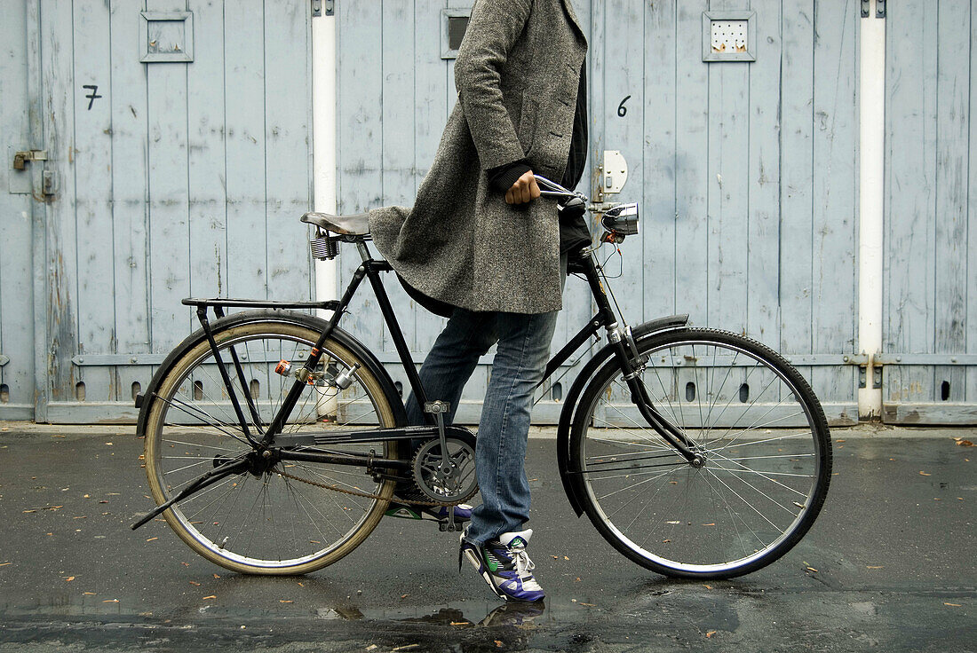 Adult, Adults, Anonymous, bicycle, bicycles, bike, bikes, biking, Blue jean, Blue jeans, Coat, Coats, Color, Colour, Contemporary, cycle, cycles, Daytime, Denim, exterior, Female, human, Impulse, Jean, Jeans, Momentum, One, One person, outdoor, outdoors, 