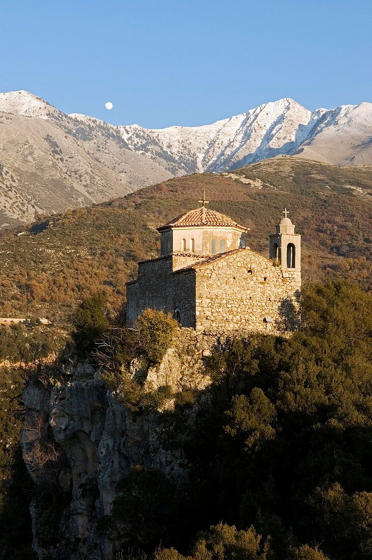 Profitas Ilias monastery above Voiro, one of the Gaitses villages, with the snow covers peak of Halasmeno in the backround, Mani Peninsular, Southern Peloponese, Greece