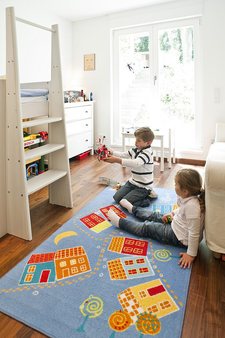 Two children playing in a child's room, Hamburg, Germany