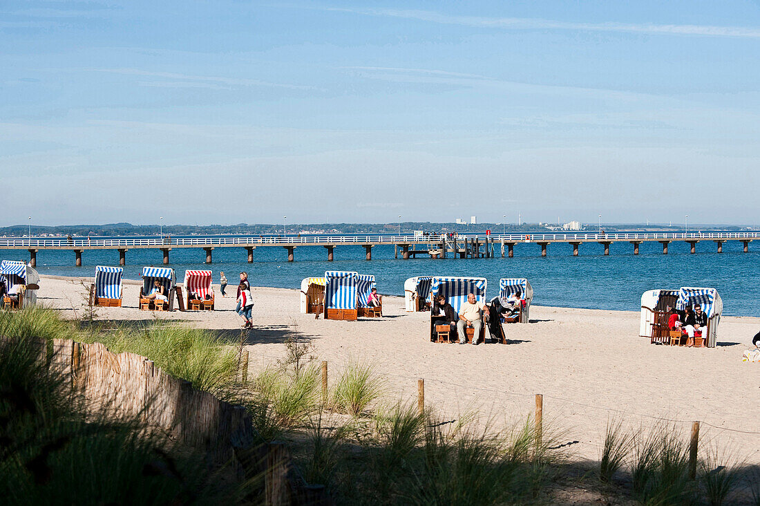 Roofed wicker beach chairs at beach, Timmendorfer Strand, Schleswig-Holstein, Germany