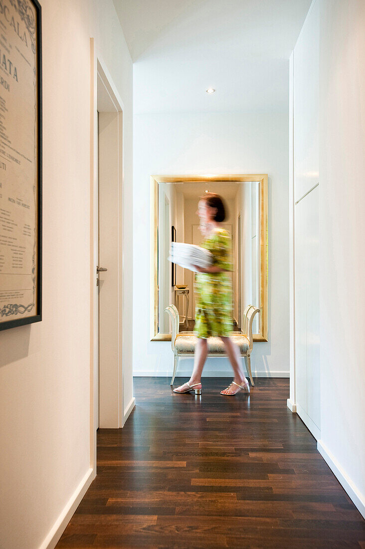 Woman passing a corridor, Hamburg, Germany