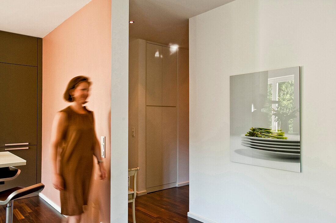 Woman walking through modern living area, Hamburg, Germany