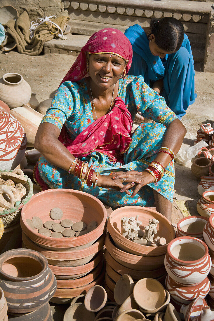 Woman selling pottery in a street, Bikaner, Rajasthan, India
