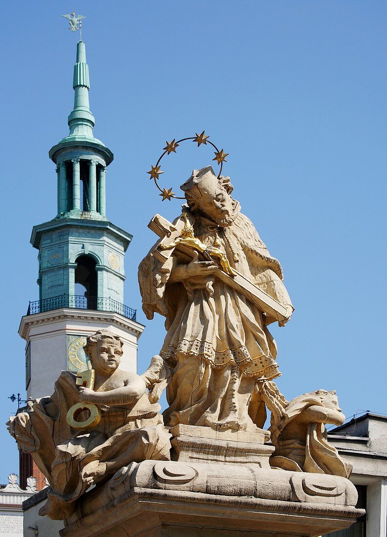 Statue St John Nepomuk religious figure holding cross with Jesus Christ Old Market Square, Poznan, Poland