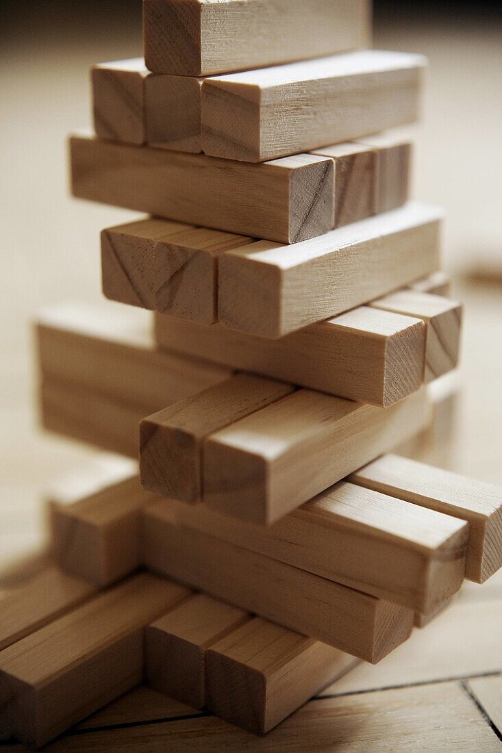 A pile of balancing wooden blocks  Low depth of field, focus not on front of block