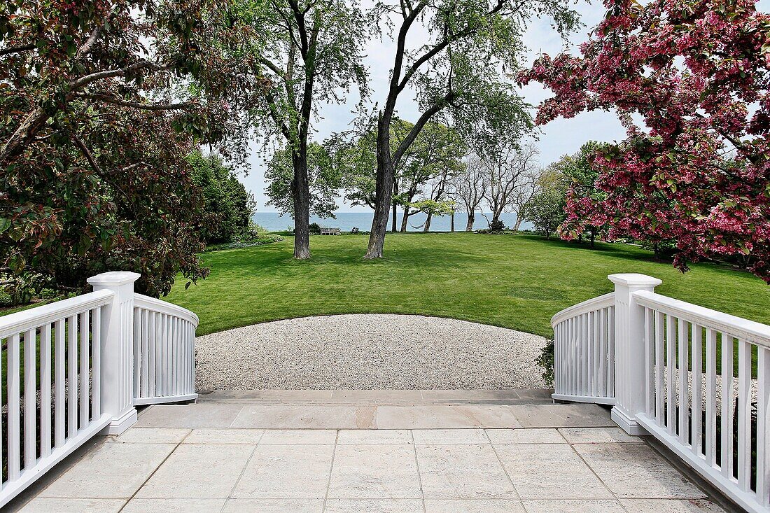 Patio steps of luxury home with lake view