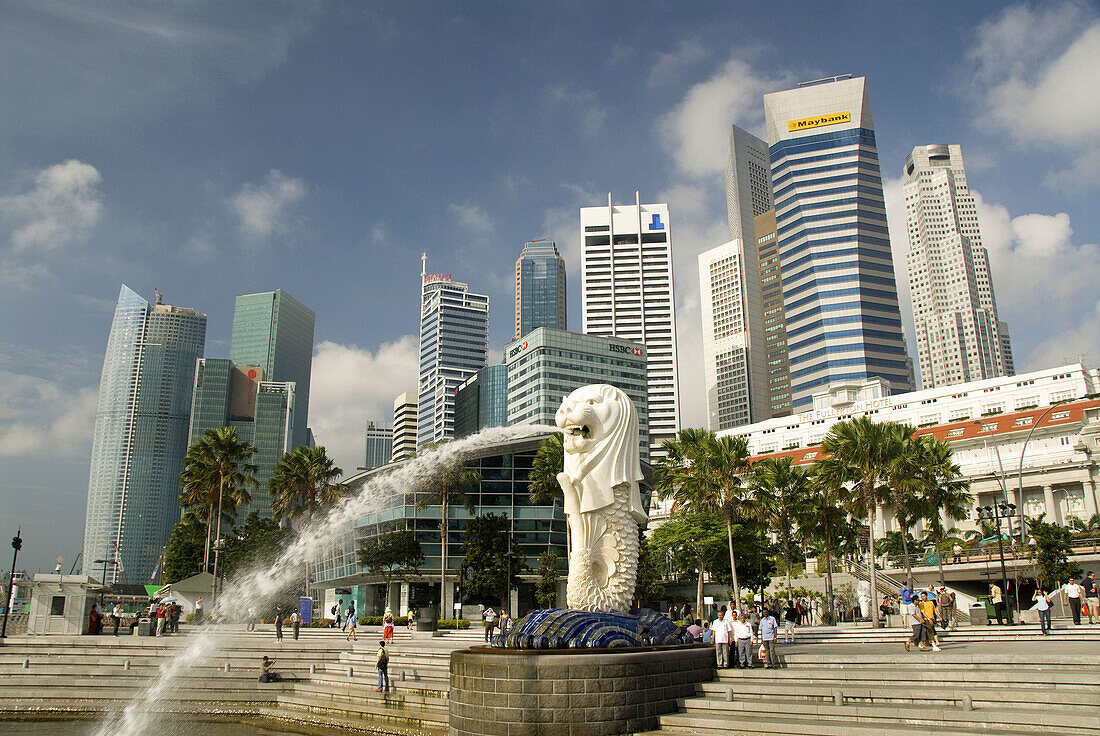 Water spray from Merlion  foreground) with city skyline in background, Singapore