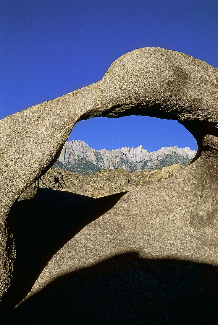 Mount Whitney seen through a granite Natural Arch, Alabama Hills, Sierra Nevada Mountains, Lone Pine, California, USA