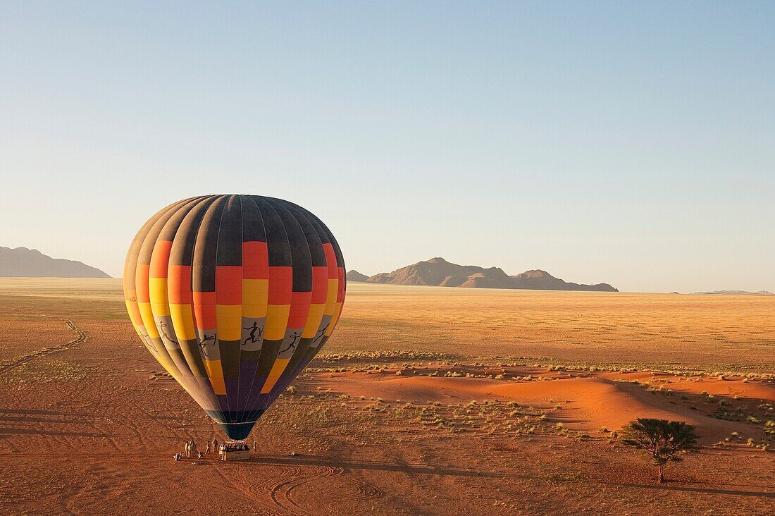 Namibia - The hot-air balloon shortly before take-off in the light of the early morning Namib Desert, NamibRand Nature Reserve, Namibia