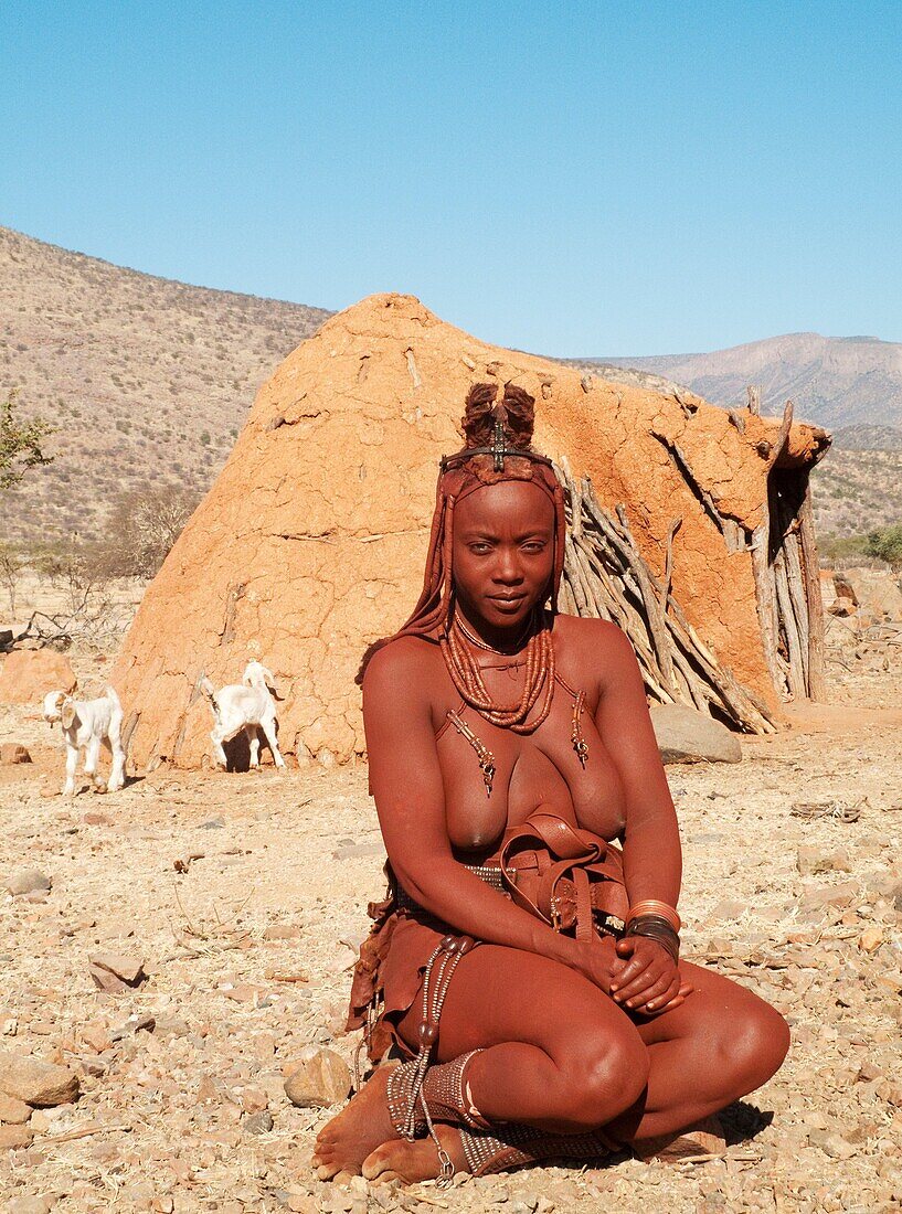 Namibia - Himba woman with the typical leather headdress of the married women In a village near the Epupa Falls Kaokoland, Kunene region, northern Namibia
