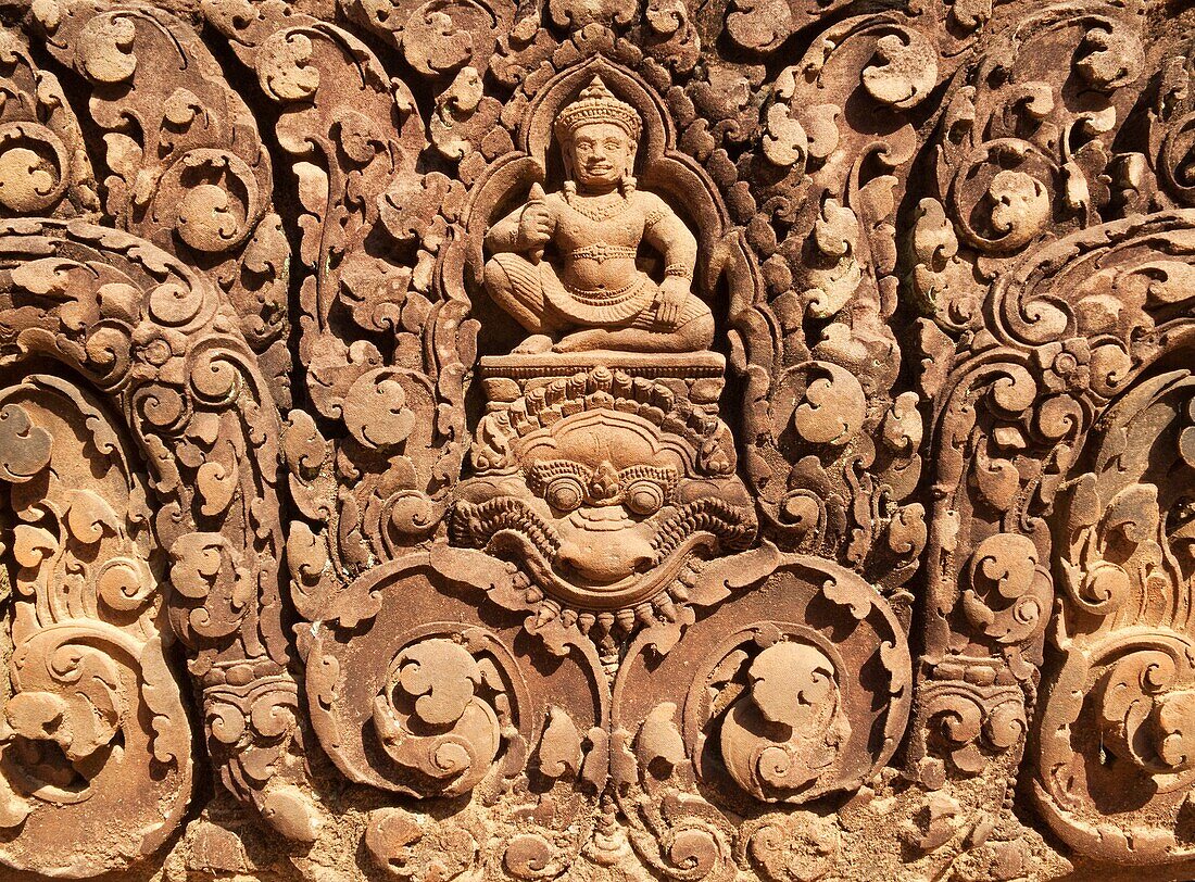 Cambodia - The temple of Banteay Srei is known for the exquisite exuberance of its sandstone carvings, here a Kala mythical all-devouring creature with bulbous eyes and the god Siva Banteay Srei is located about 25km northeast of the main group of temple