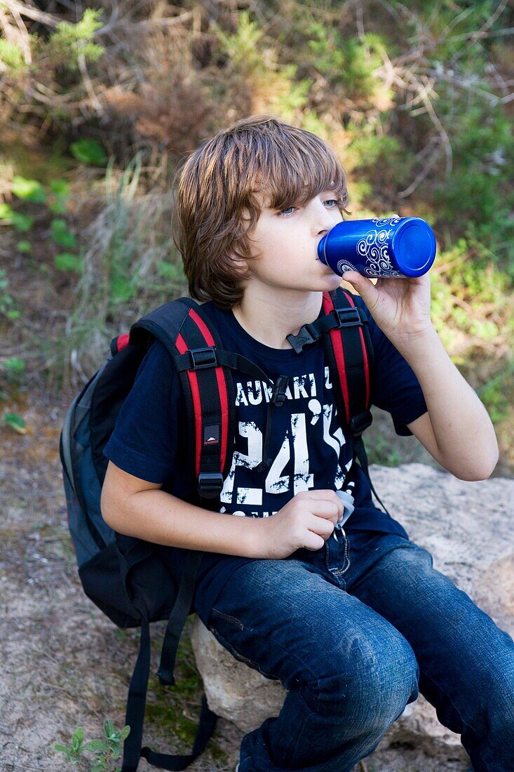 backpack, bottle, boy, break, break-time, brown hair, Caucasian ethnicity, chestnut hair, child, childhood, Color image, contemporary, country, day, drink, drinking, hike, hiking, human, infancy, kid, leisure, Male, one, one person, outdoor, pause, people