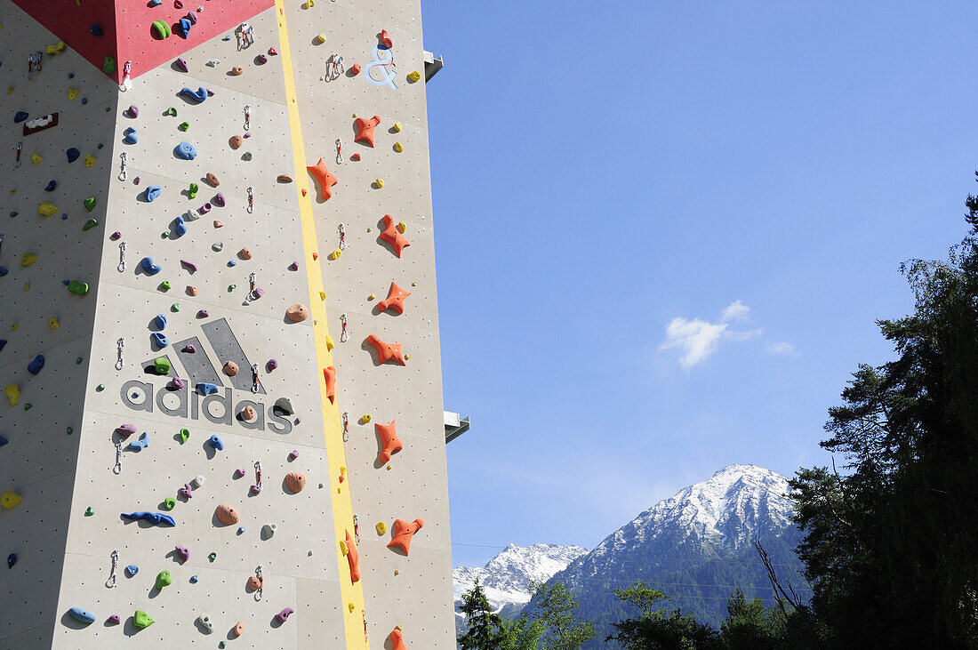 Artificial climbing wall on a bridge pillar above the river Inn with mountains in the background, Funpark Area 47, Oetztal valley, Tyrol, Austria
