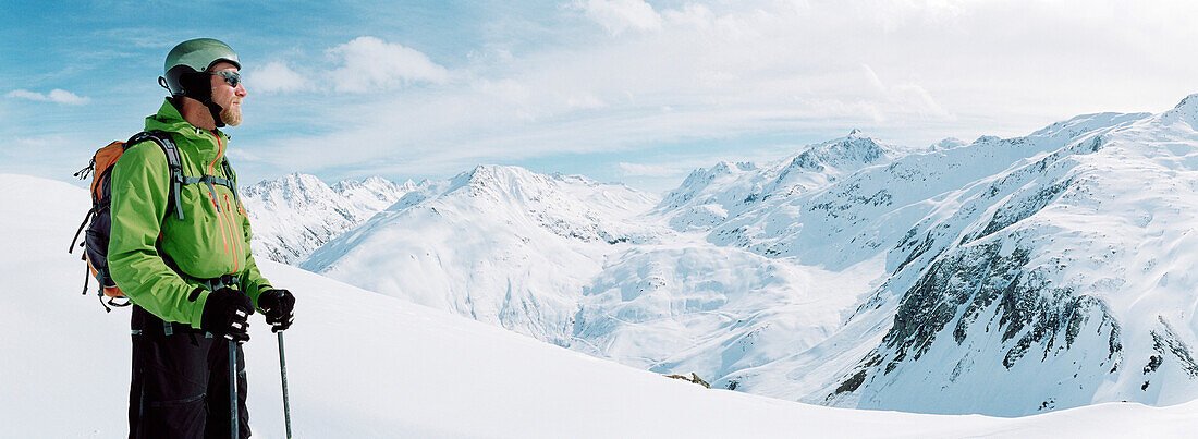 Skier in front of mountain range, Disentis, Oberalp pass, Canton of Grisons, Switzerland