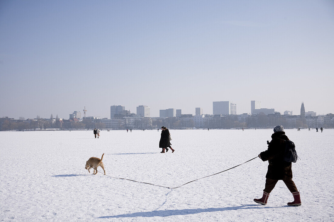Persons on frozen outer Alster in winter, Hamburg, Germany