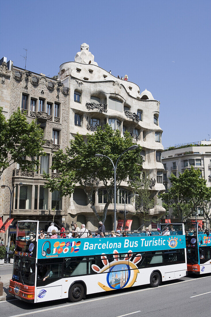 City sightseeing bus in front of building by Antoni Gaudi, Barcelona, Catalonia, Spain, Europe