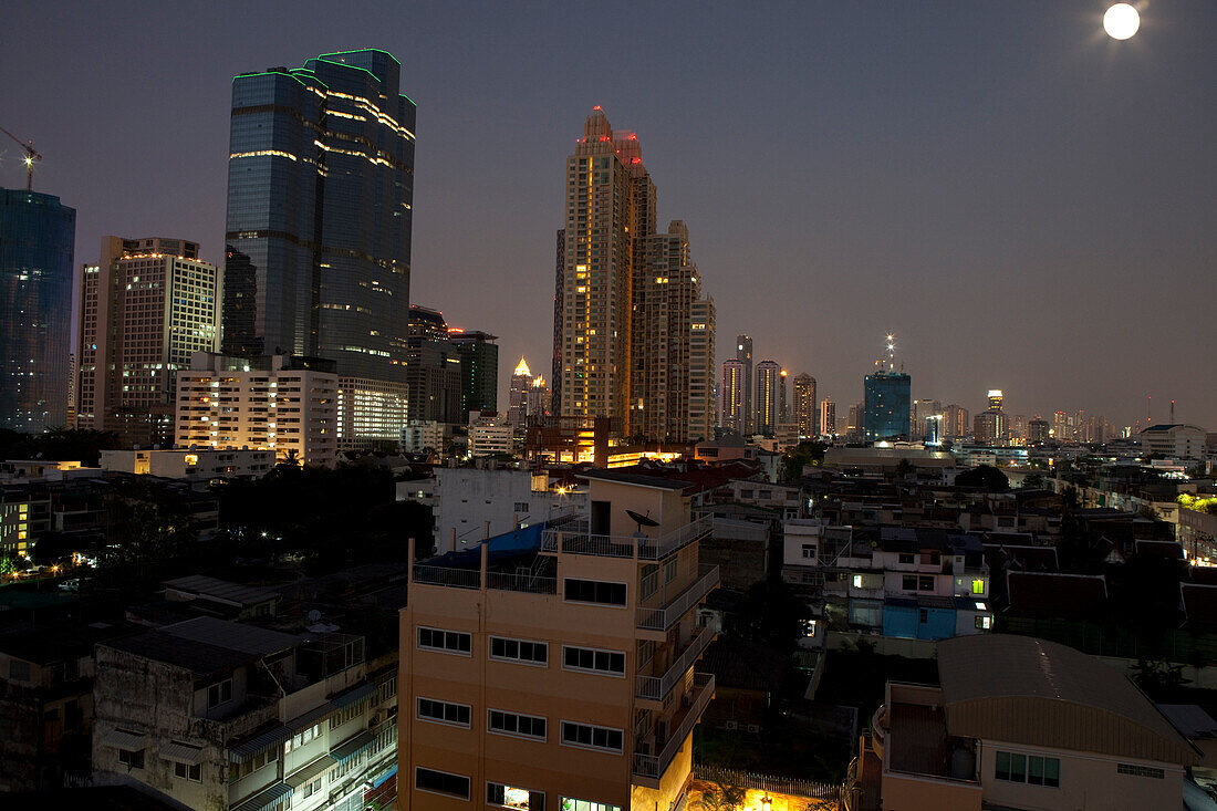 Full moon over Sathorn business area, Bangkok, Thailand