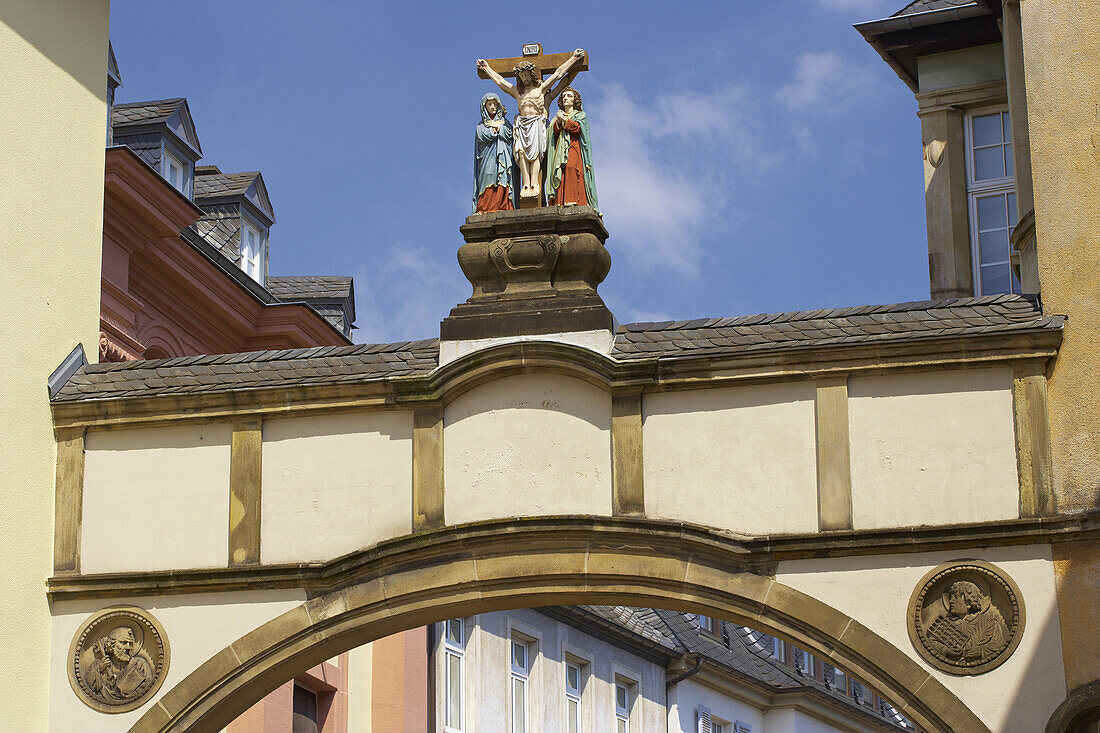 Archway with sculpture of crucification in Liebfrauenstraße, Trier on Mosel, Rhineland-Palatinate, Germany, Europe