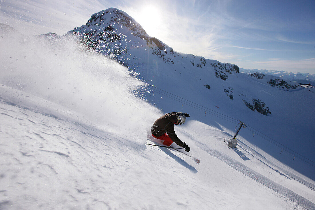 Skier downhill skiing at Blackcomb Peak, British Columbia, Canada