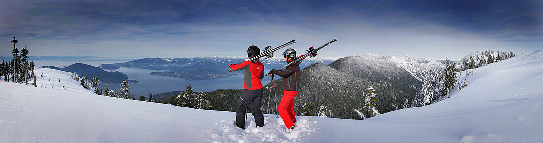 Skiers enjoying view over Lions Bay and Vancouver Island, Cypress Mountain, British Columbia, Canada