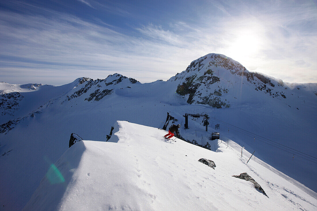 Skier downhill skiing at Blackcomb Peak, British Columbia, Canada