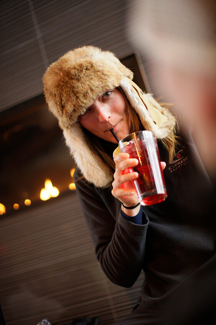 Woman with a drink in Cypress Creek Day Lodge, Cypress Provincial Park, British Columbia, Canada