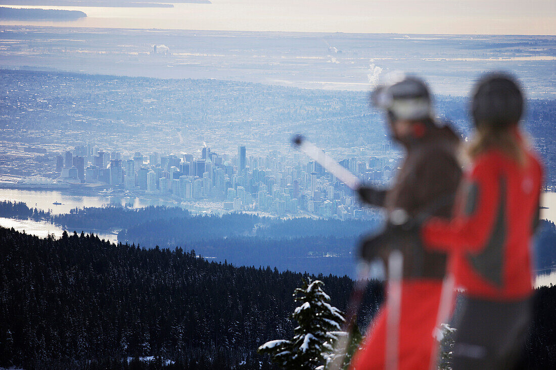 Skiers looking over Vancouver, British Columbia, Canada