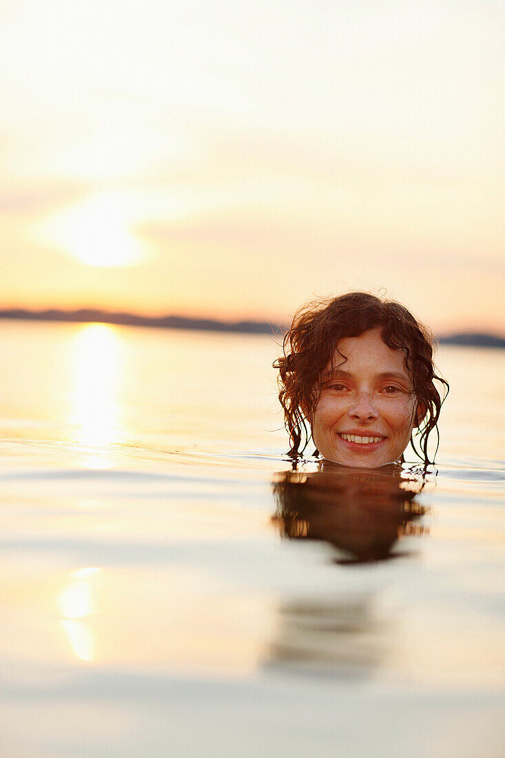 Woman bathing in lake Starnberg, Ambach, Munsing, Bavaria, Germany