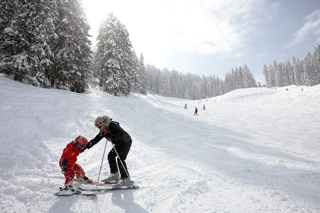 Mother and daughter near slope, skiing area Heuberg, Heubergmuldenlift, Hirschegg, Kleinwalsertal, Vorarlberg, Austria