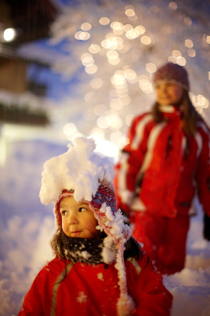 Girls playing in snow, Hotel Chesa Valisa, Hirschegg, Kleinwalsertal, Vorarlberg, Austria