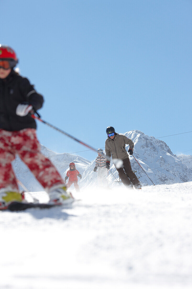 Family skiing, Schlosslelift, mount Barenkopf in background, Hirschegg, Kleinwalsertal, Vorarlberg, Austria