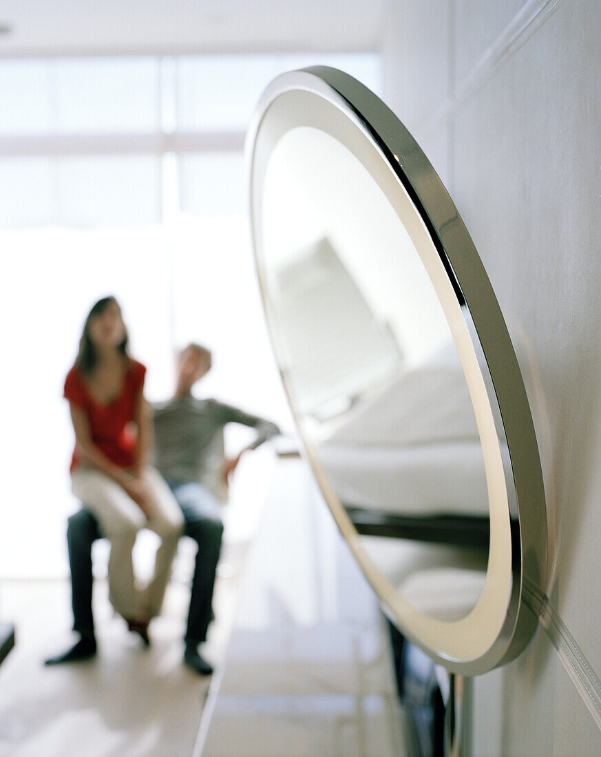 Young woman sat on boyfriends knees, Hotel room on the 2nd Floor, Designed by Norman Foster, Hotel Silken Puerta America, Madrid, Spain