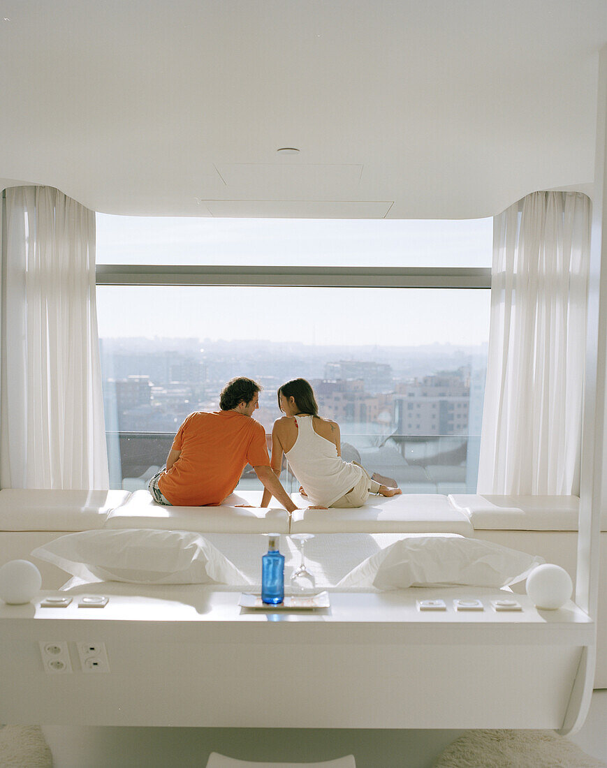 Couple sat at the window and enjoying the view, Room on the 8th Floor, Designed by Kathryn Findlay, Hotel Silken Puerta America, Madrid, Spain