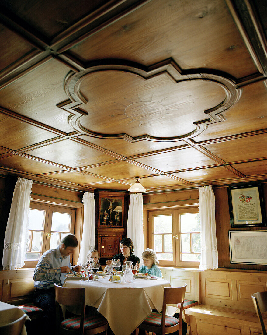 Family having dinner in the restaurant of organic Hotel Chesa Valisa, Hirschegg, Kleinwalsertal, Austria