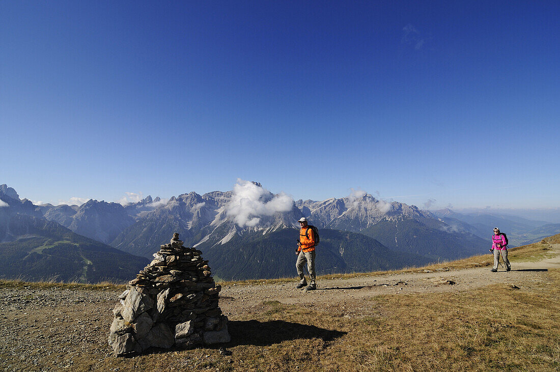 Hikers at Karnischer Höhenweg under blue sky, Val Pusteria, Dolomites, South Tyrol, Italy, Europe