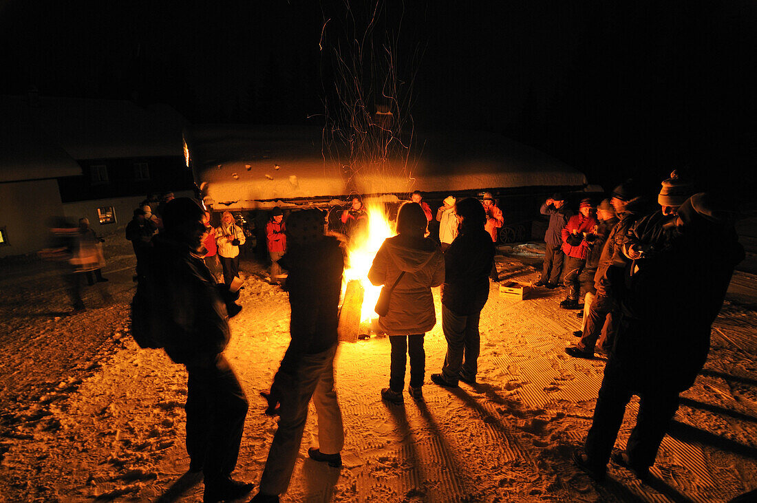 People at bonfire in front of Hindenburg hut, Hemmersuppenalm, Reit im Winkl, Chiemgau, Upper Bavaria, Bavaria, Germany, Europe