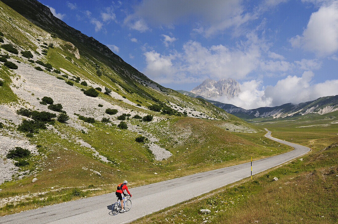 Cyclist at Campo Imperatore, summit of Corno Grande, Gran Sasso National Park, Abruzzi, Italy, Europe