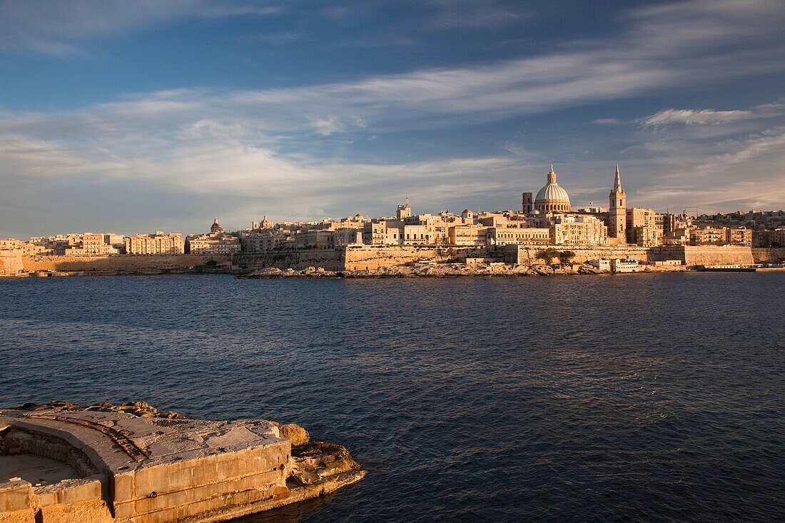 Malta, Valletta, skyline with St Paul's Anglican Cathedral and Carmelite Church from Sliema, sunset