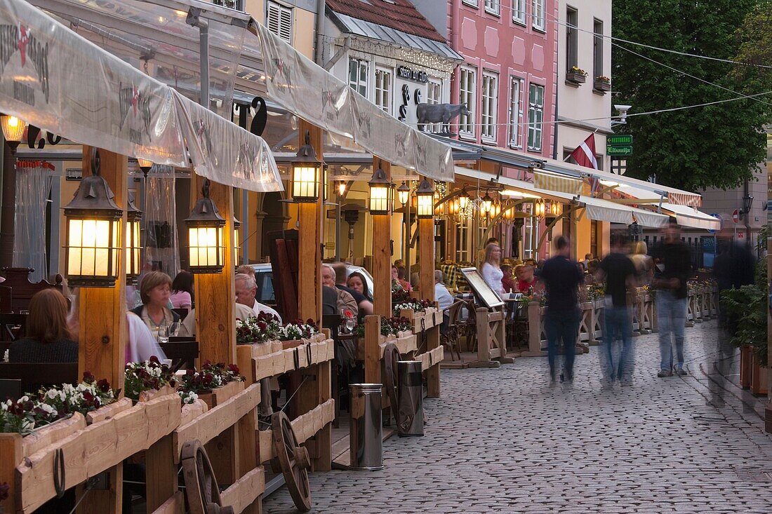 Latvia, Riga, Vecriga, Old Riga, Livu Laukums Square cafes, dusk
