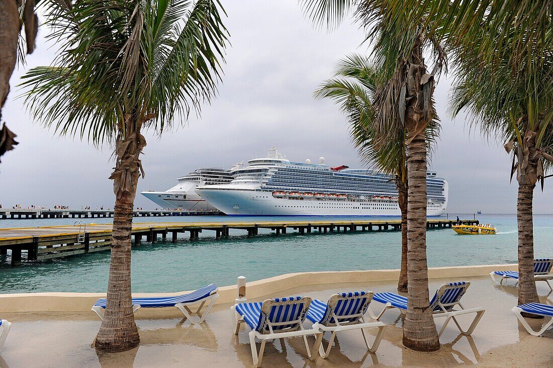 Blue lounge chairs near Caribbean Cruise Ship in Puerta Maya and Cozumel Mexico