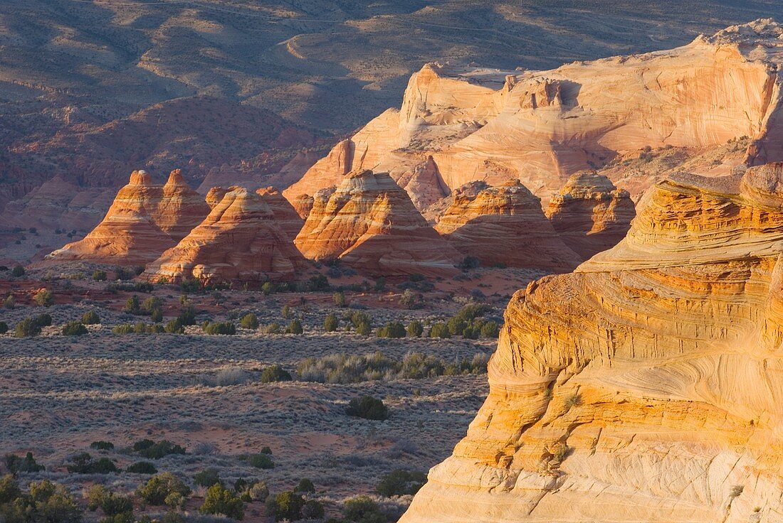 Setting sun illuminating cross-bedding in sandstone buttes of South Coyote Buttes, Vermilion Cliffs Wilderness Utah