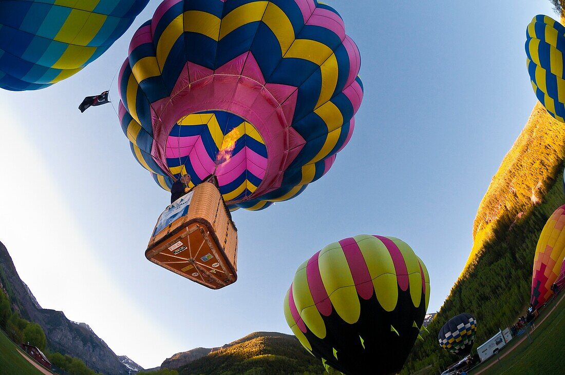 Hot air balloons flying above Telluride during the Telluride Balloon Festival, Telluride, Colorado USA