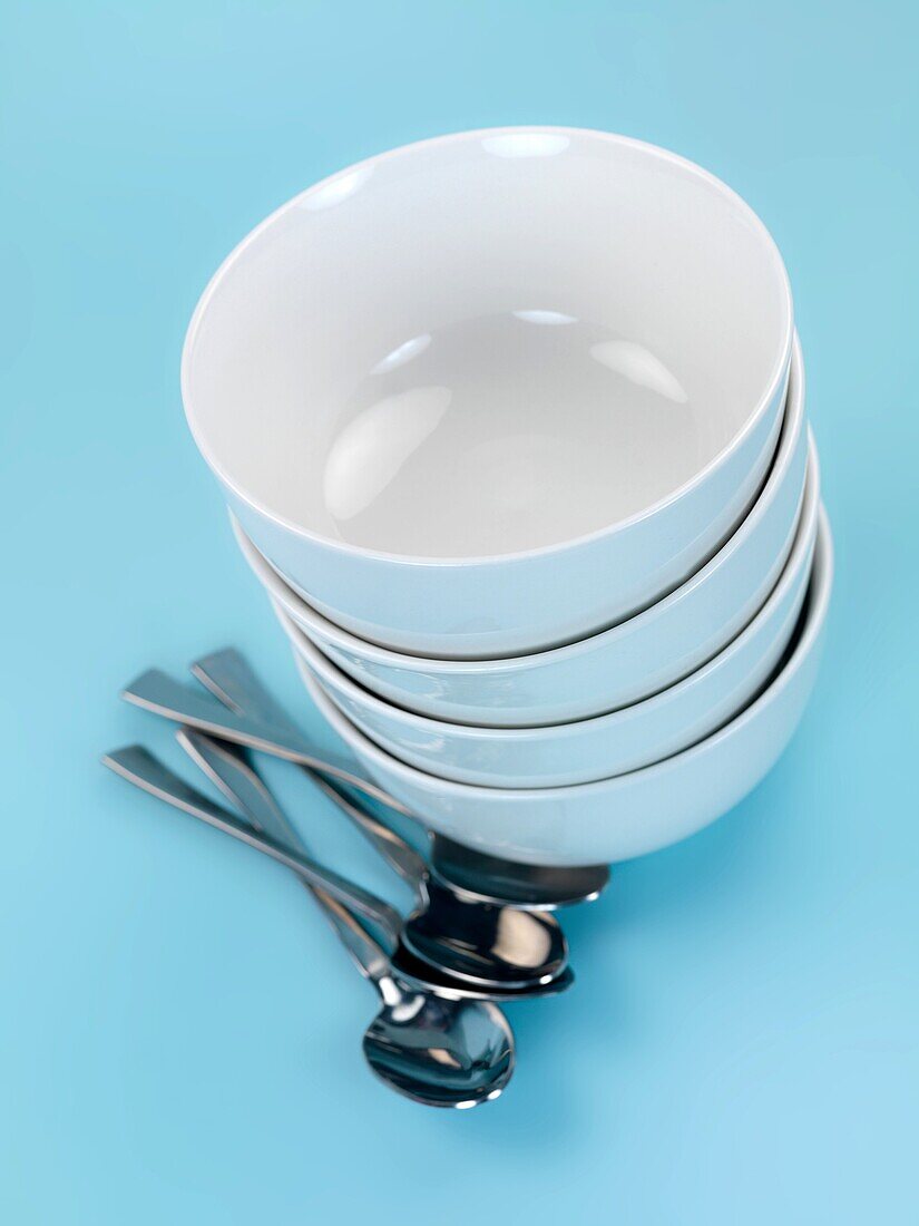 Plates and cutlery isolated against a blue background