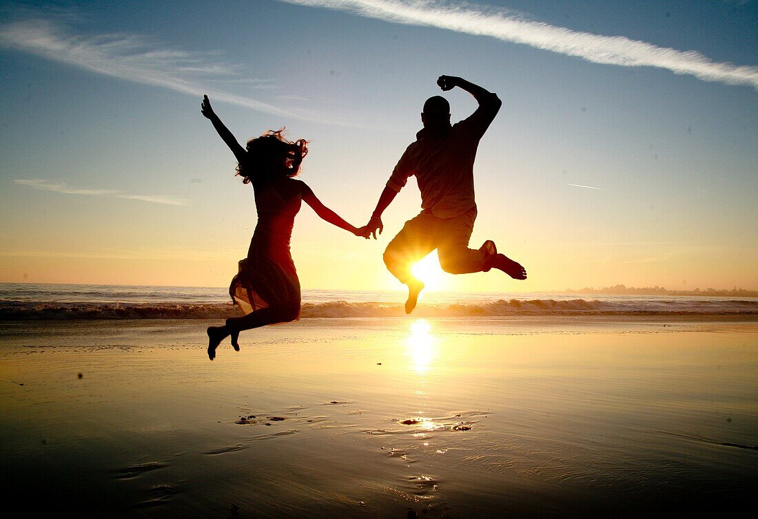 Beach fun, Couple, Fun couple, Happy day, Holding hands, Jumping, Love, Sunset couple, Valentine's day, G98-1034930, agefotostock