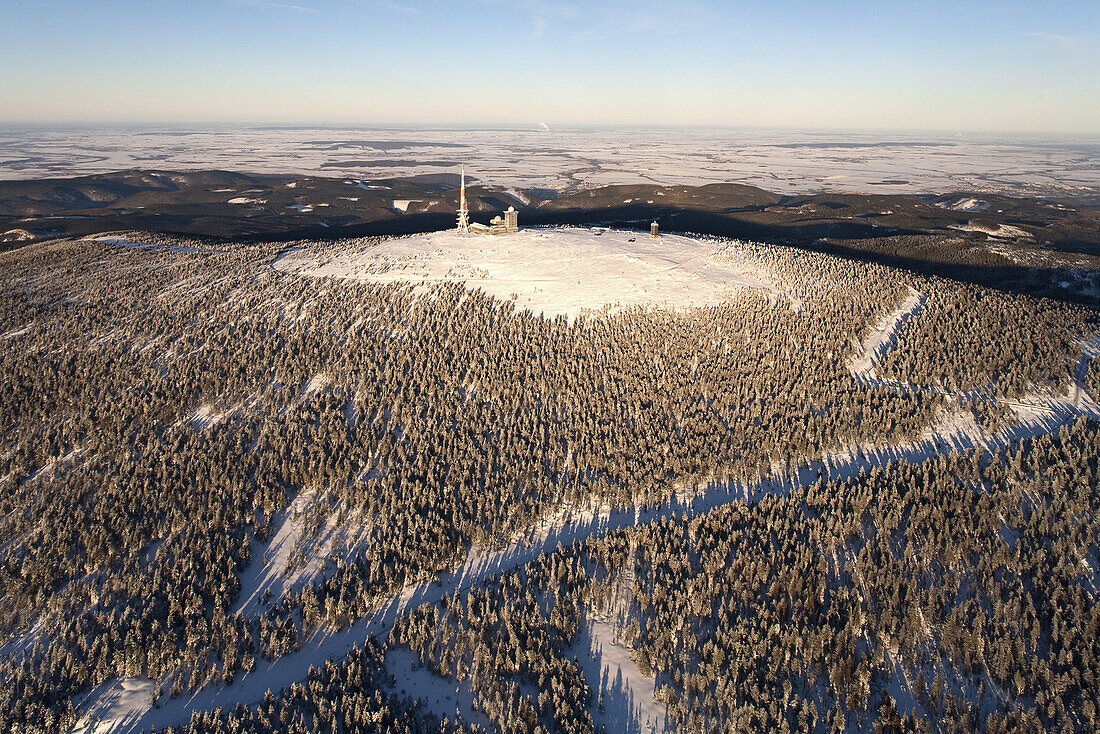 Aerial view above the snow covered Brocken mountain in Harz National Park with transmitter site, Saxony-Anhalt, Germany