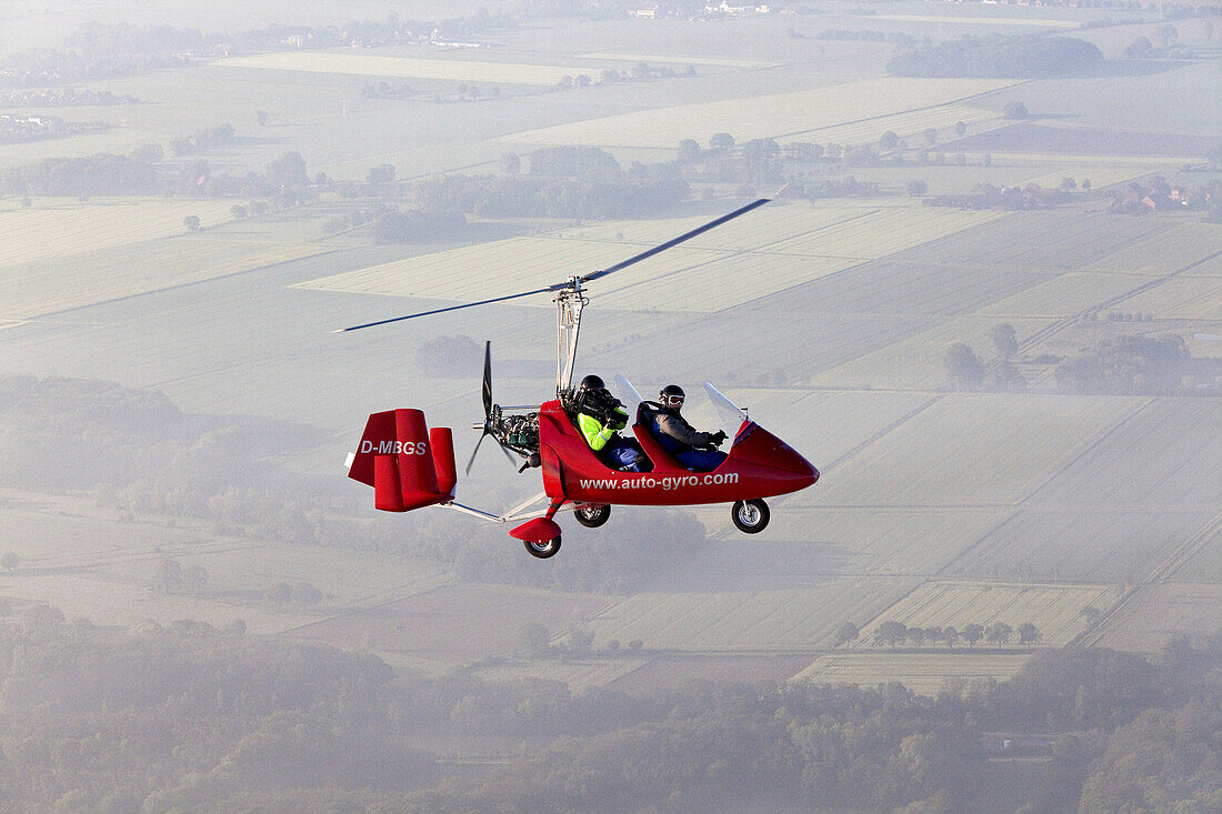 Aerial view of a two-seater autogyro, gyrocopter with cameraman, Lower Saxony, Germany